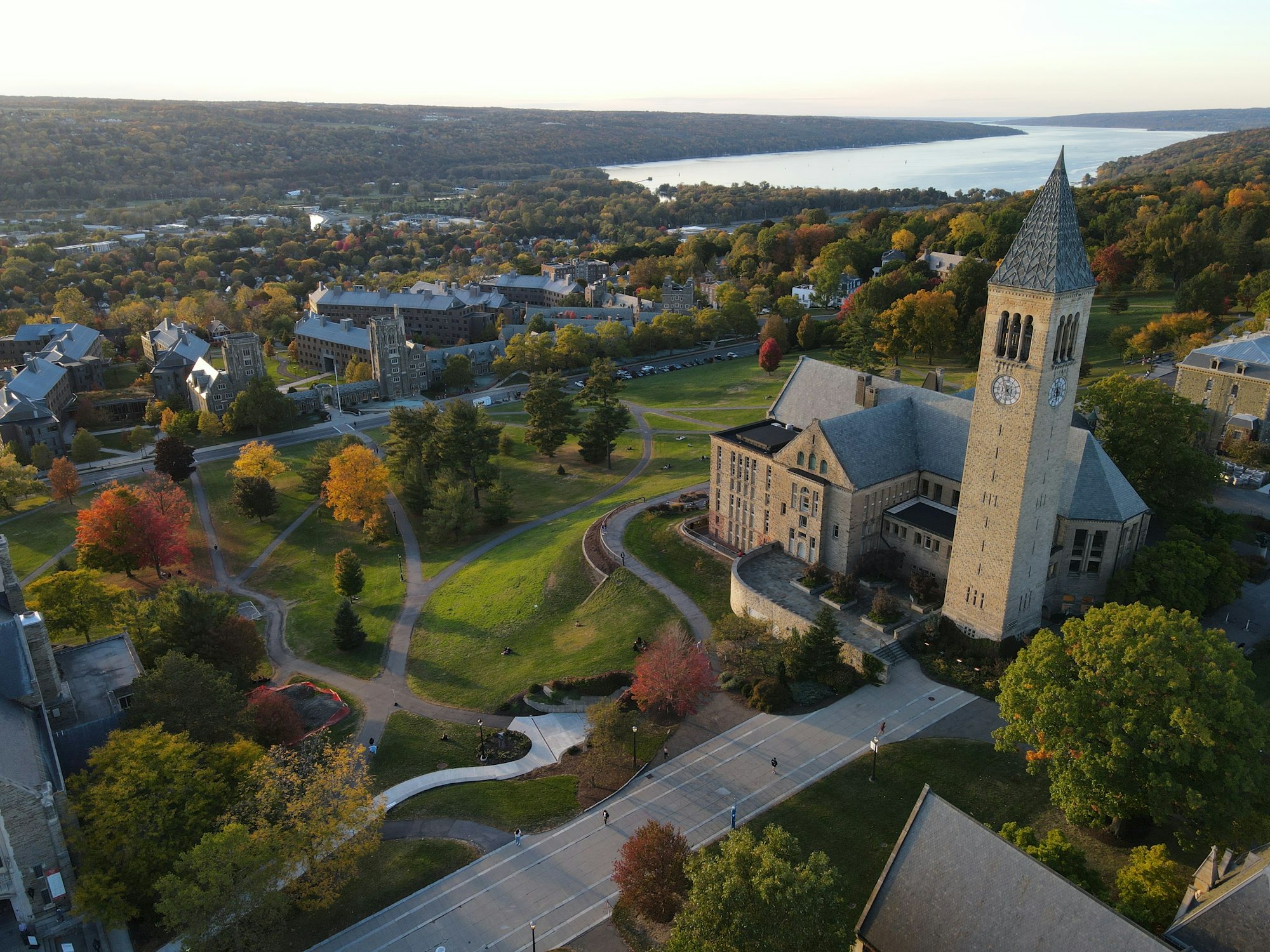 Aerial view of McGraw Tower and Libe Slope above Cayuga Lake in autumn