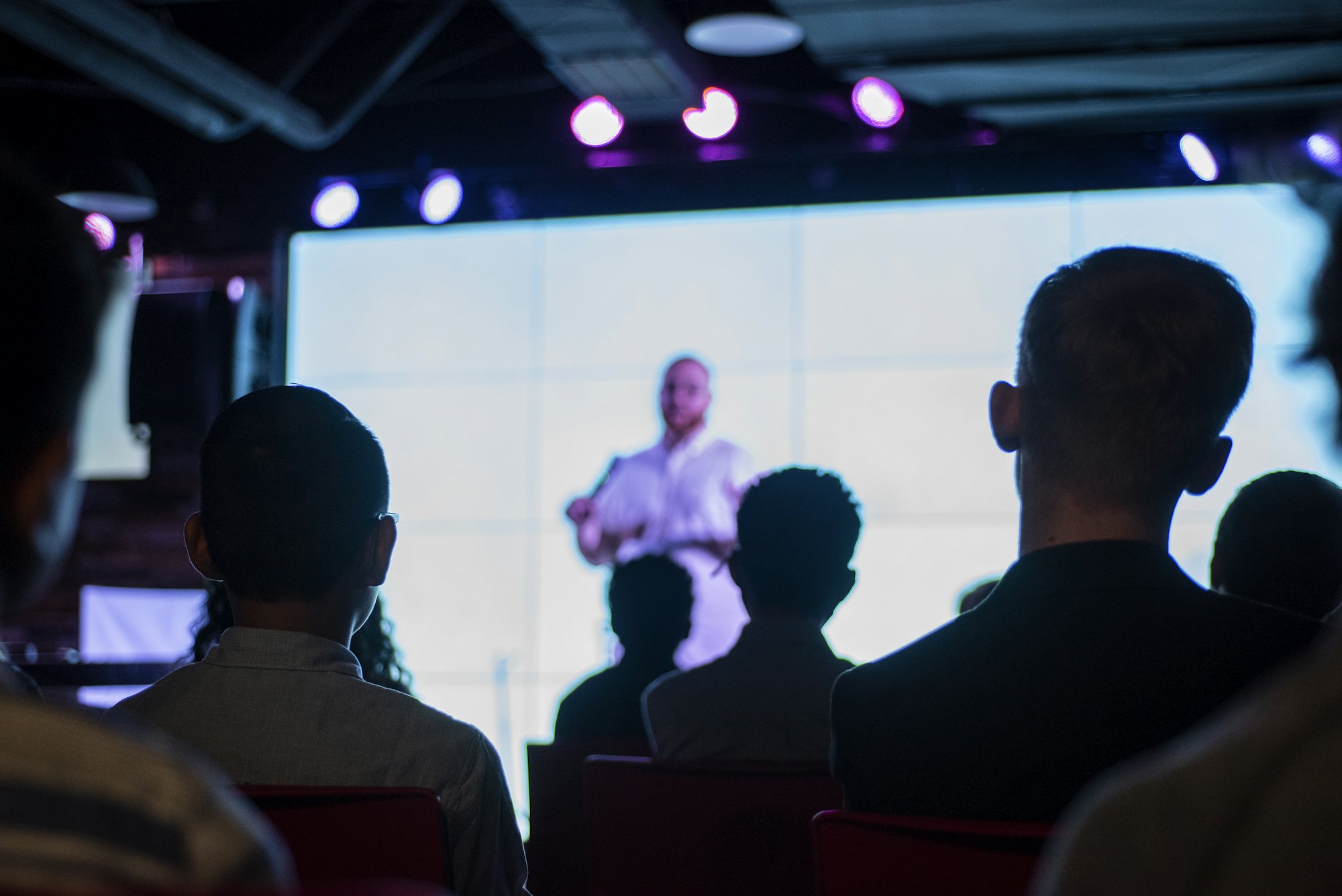 An audience watching a speaker on stage